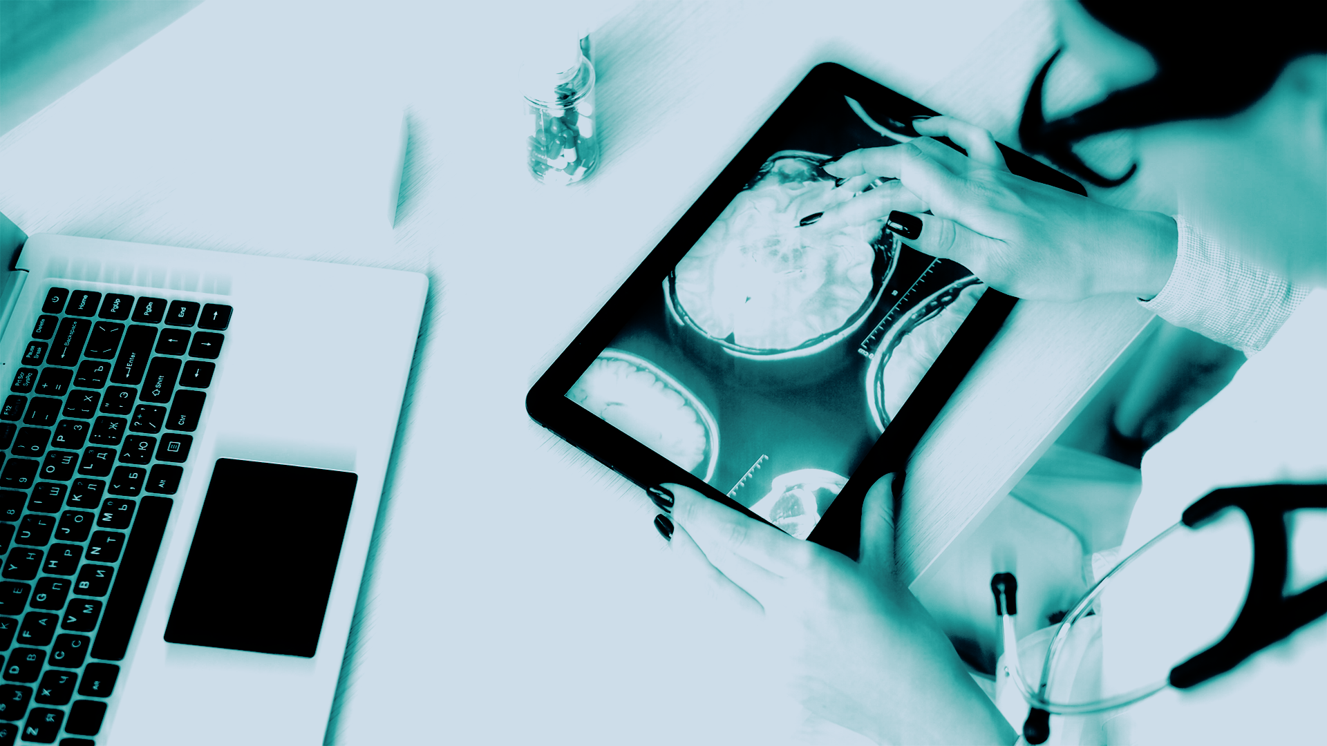 Clinician reviewing medical brain scans on a tablet